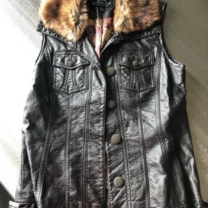 Leather and fur vest. Never worn. Like new.